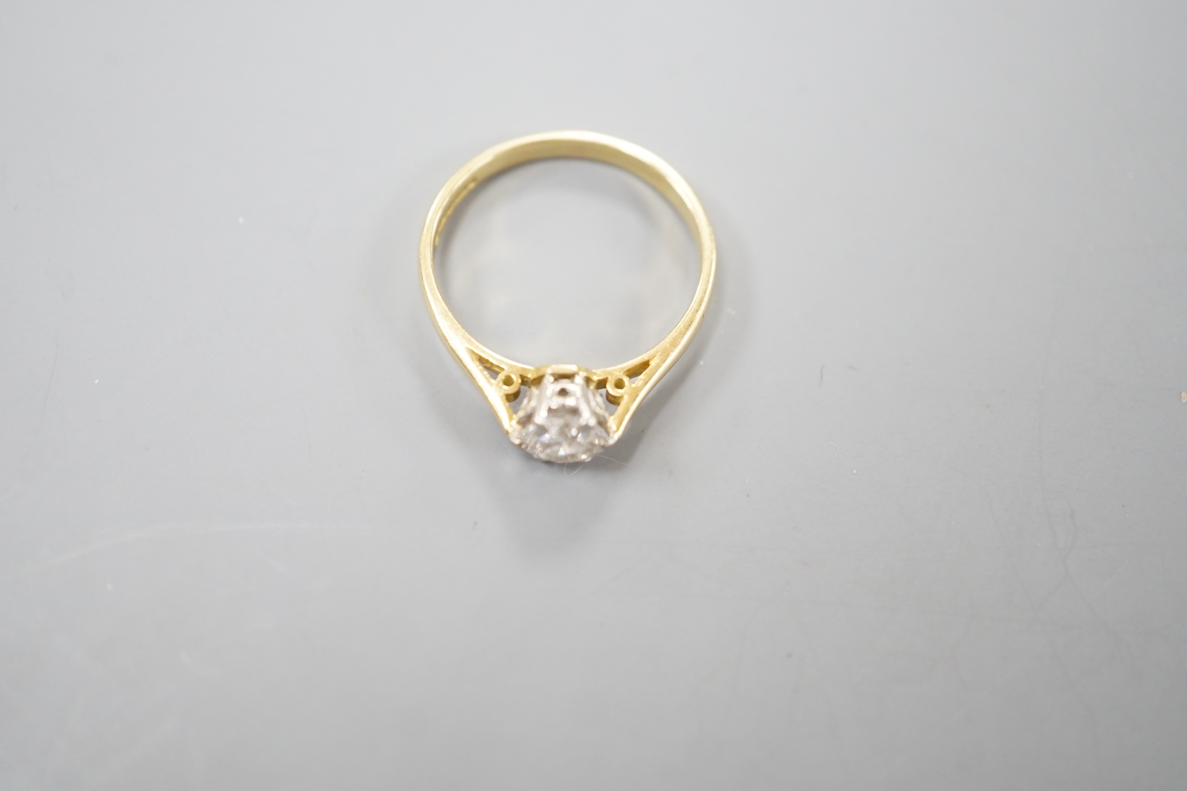 A modern 18ct gold and solitaire diamond ring, size O, gross weight 3 grams